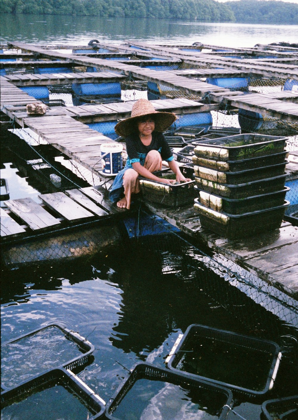 girl sitting on wooden dock