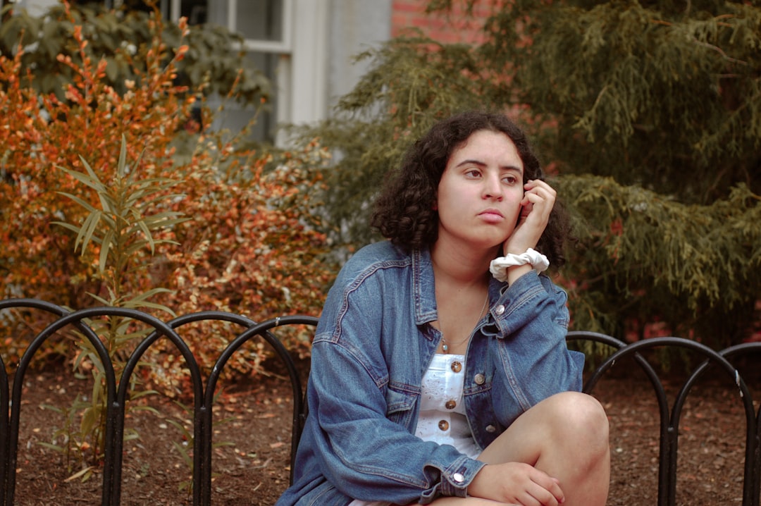 women's blue denim jacket close-up photography