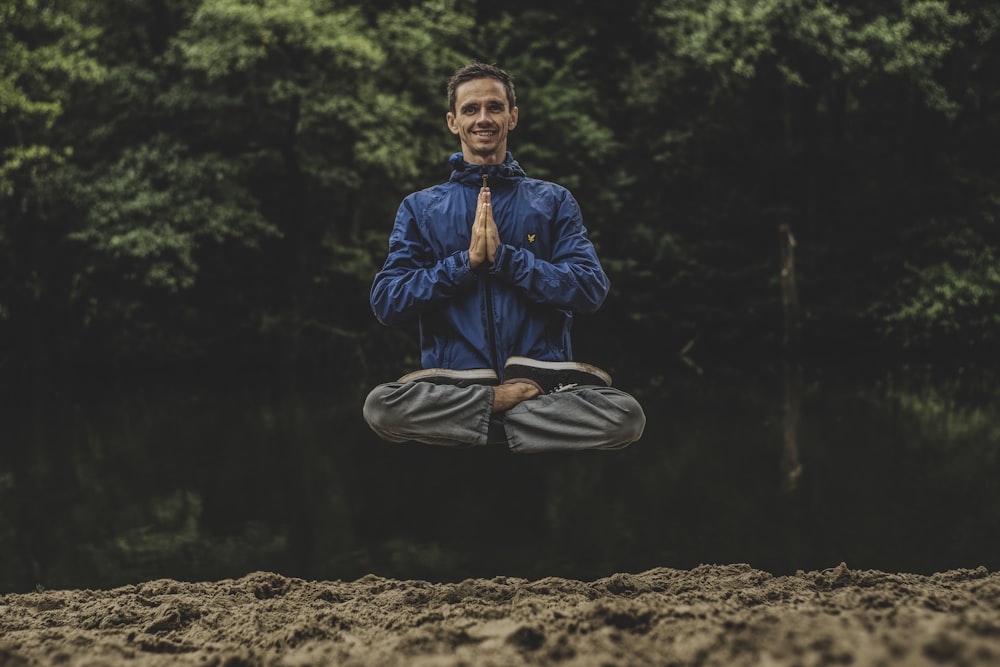 man wearing blue full-zip jacket floating