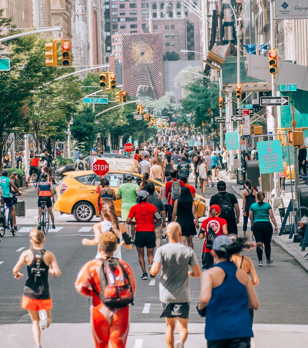 people running on street with traffic lights