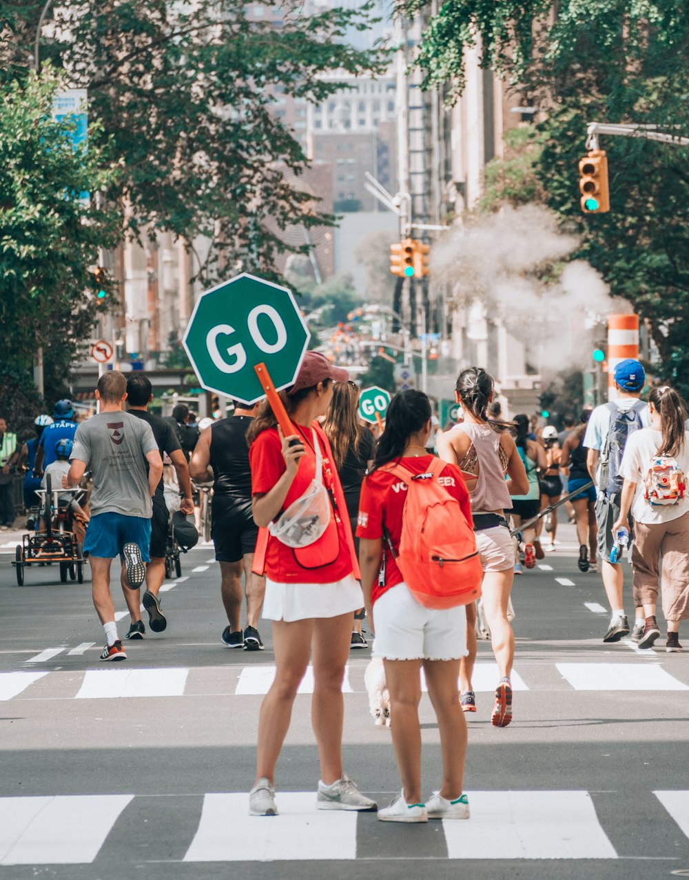 woman in red top holding Go sign