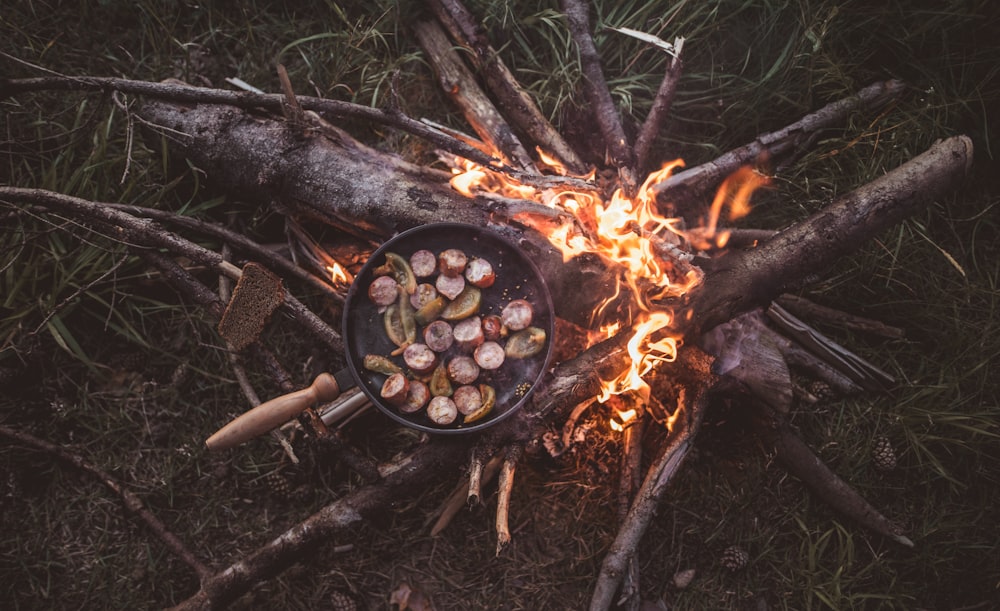 food in cooking pot with fire