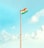 A tall flagpole with the Indian national flag waving at the top against a clear, bright sky. The sky features a gradient of blue hues with scattered white clouds.