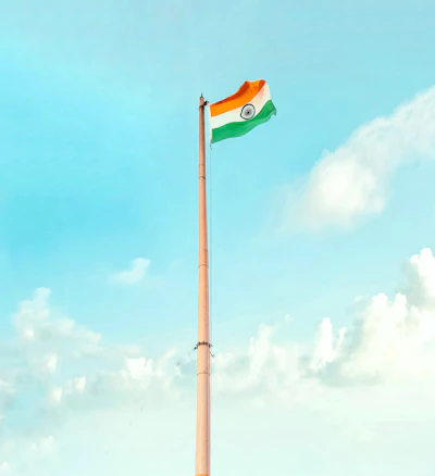 Close-up of the Indian flag waving proudly against a clear sky background.
