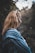 standing woman in blue and black aztec jacket