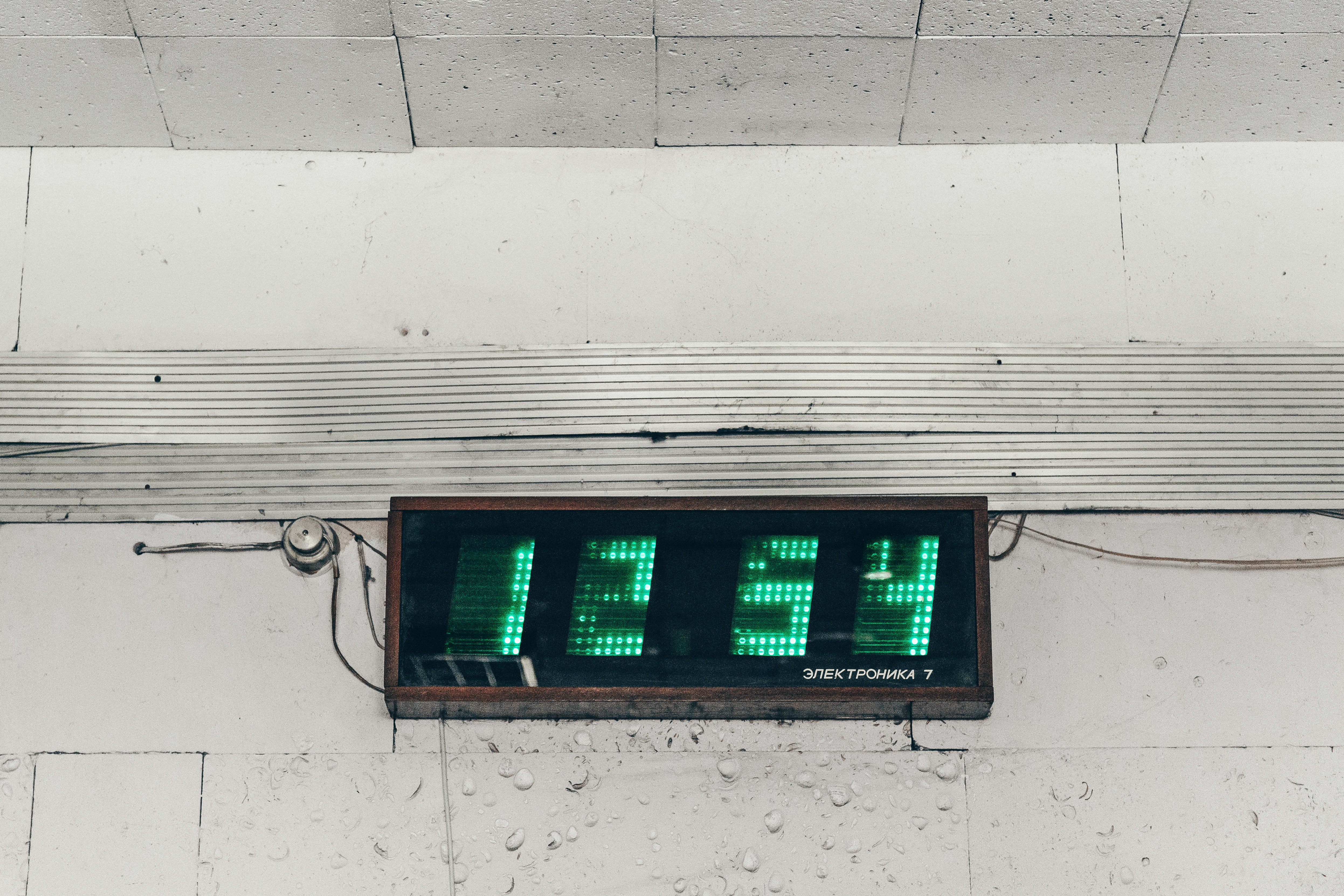 black and green digital clock displaying 1254