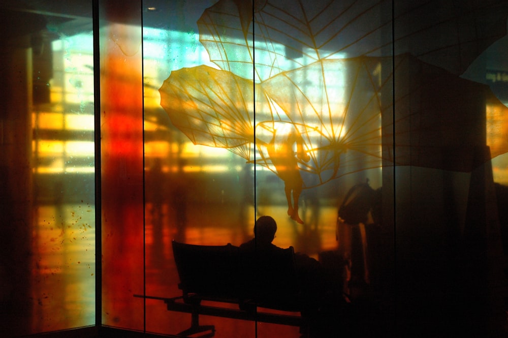 silhouette of person sitting on bench