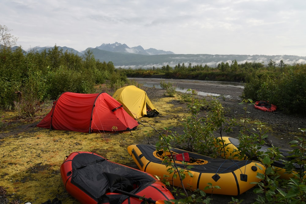 two red and yellow tents on grass