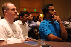 A panel of people seated at a table facing an audience