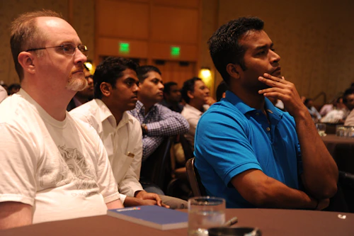 A panel of people seated at a table facing an audience
