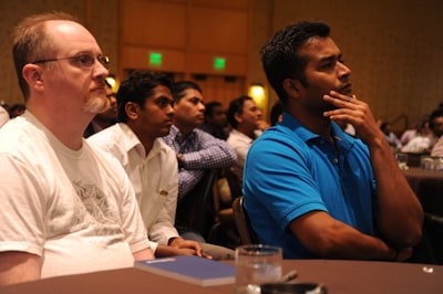 men sitting in front of table patuxet indians google meet background