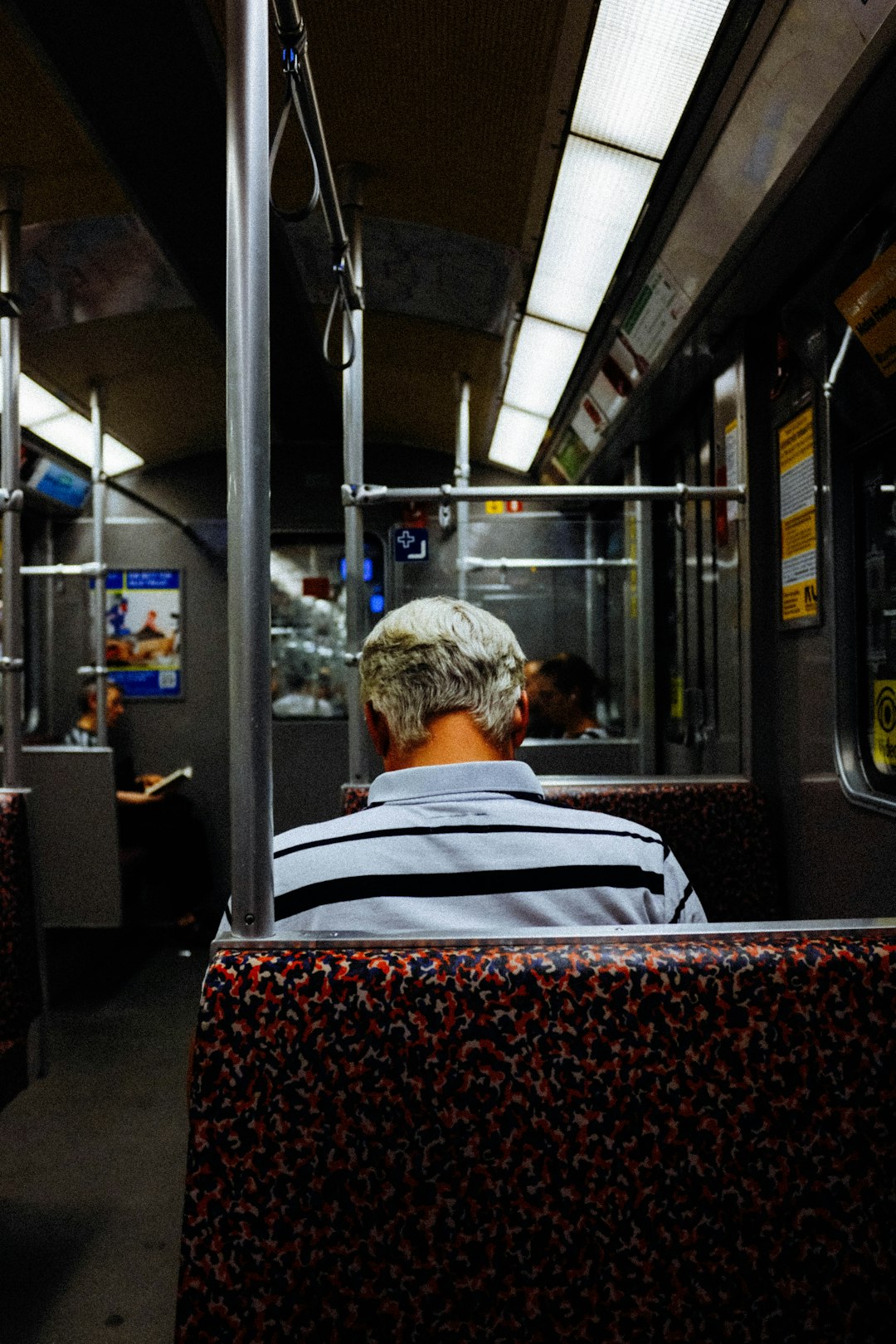 man sitting on train seat