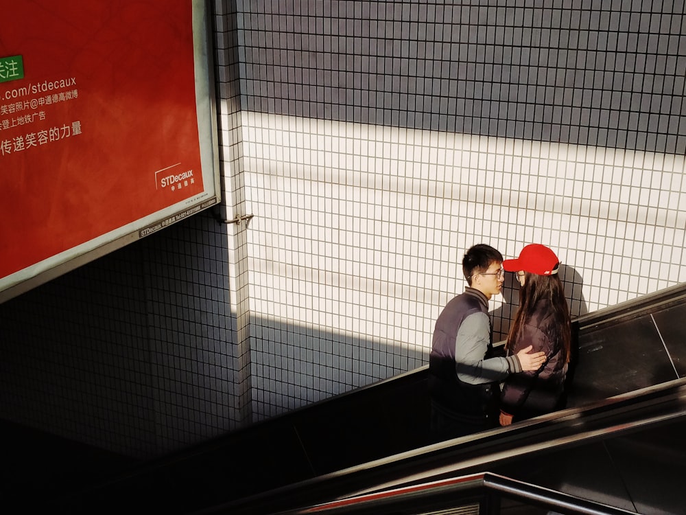 man and woman on escalator