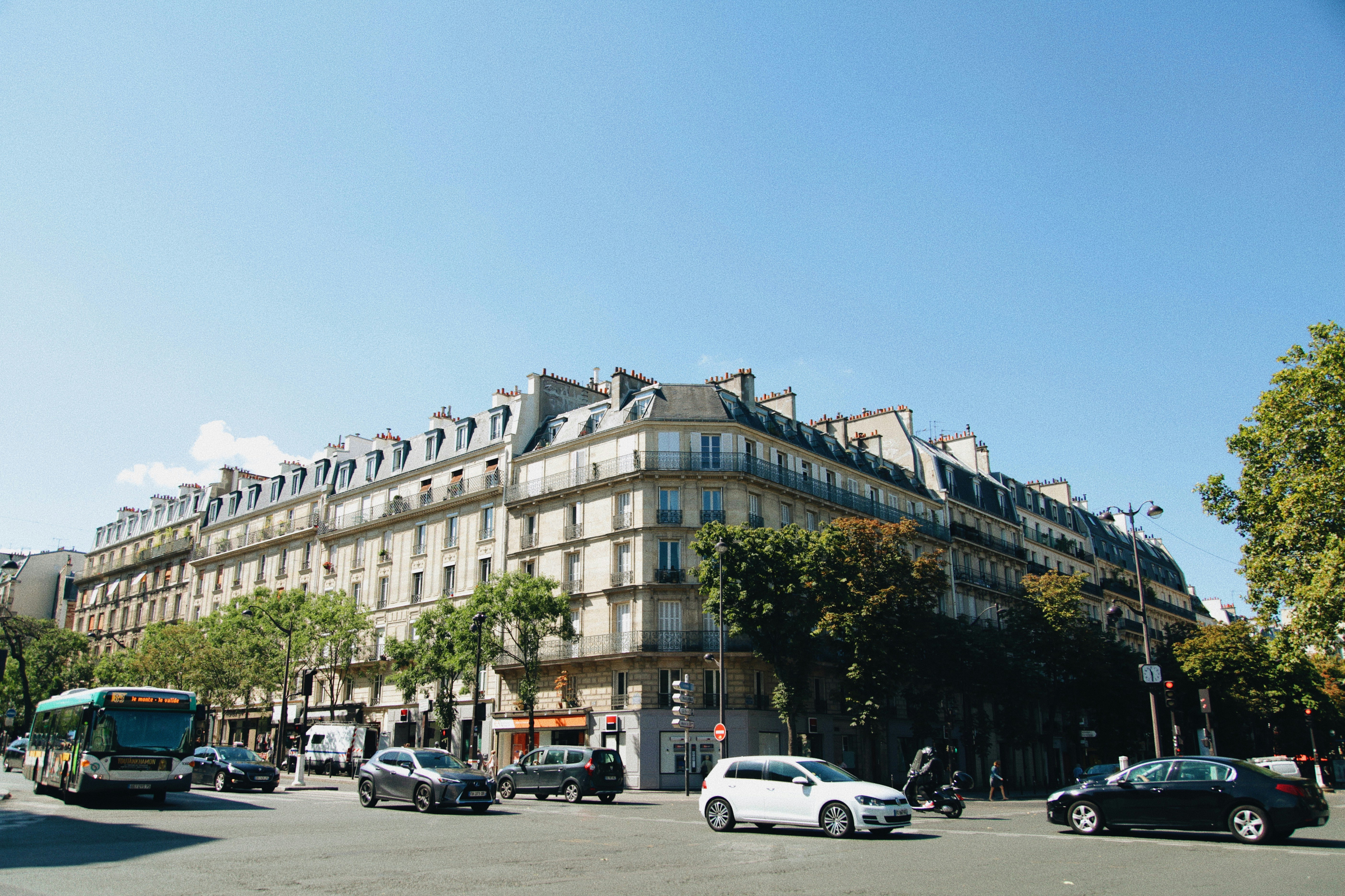 vehicles in front of building under blue sky