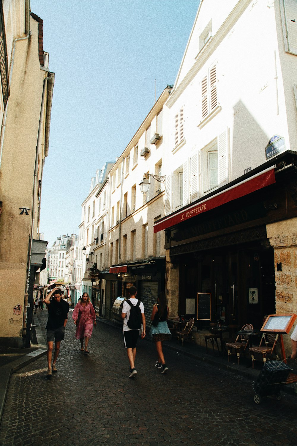 people walking on street between buildings