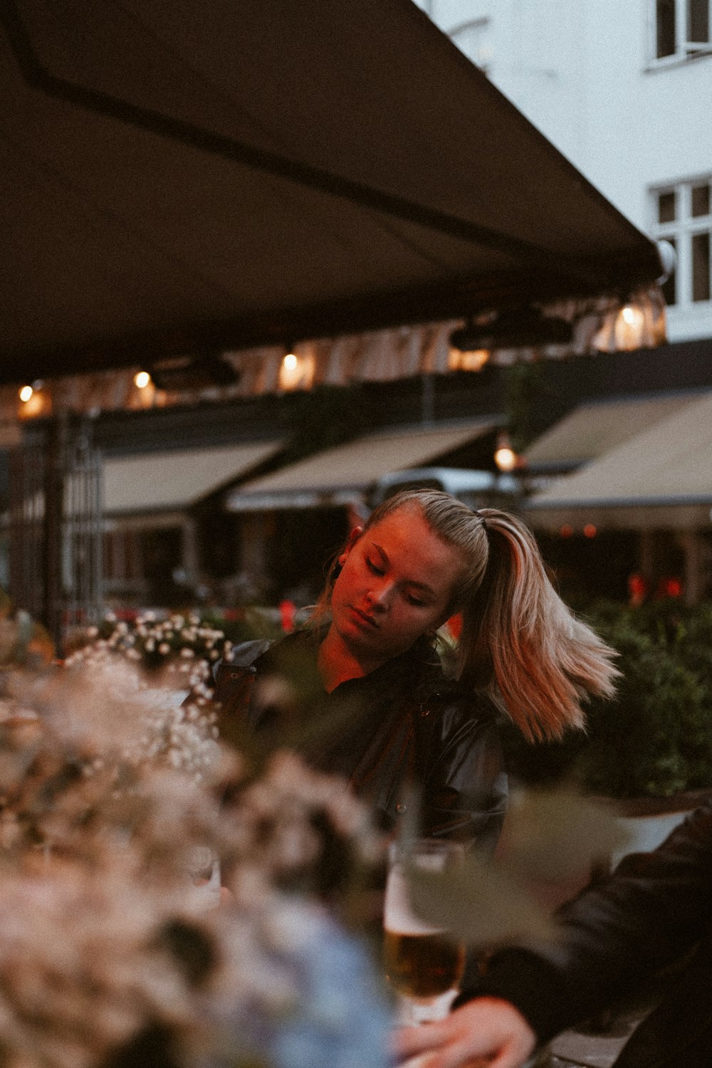 woman sitting on chair under patio umbrella