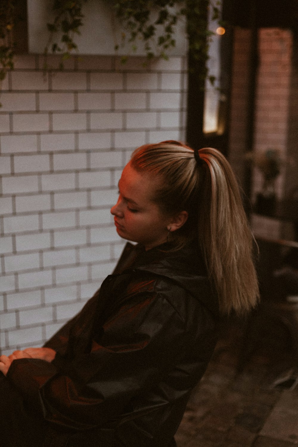 woman wearing black jacket sitting on chair