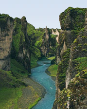 a river running through a lush green valley