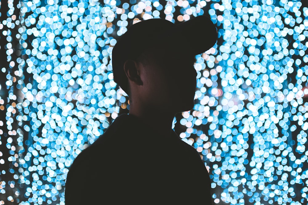 silhouette of man wearing cap