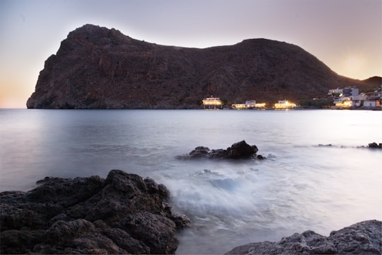 body of water across brown hills in Lentas Greece