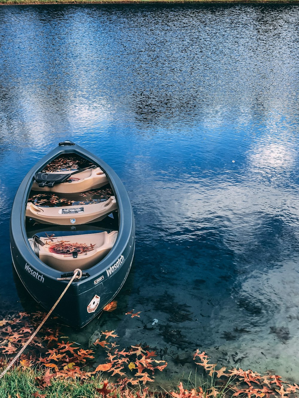 green and brown boat on body of water