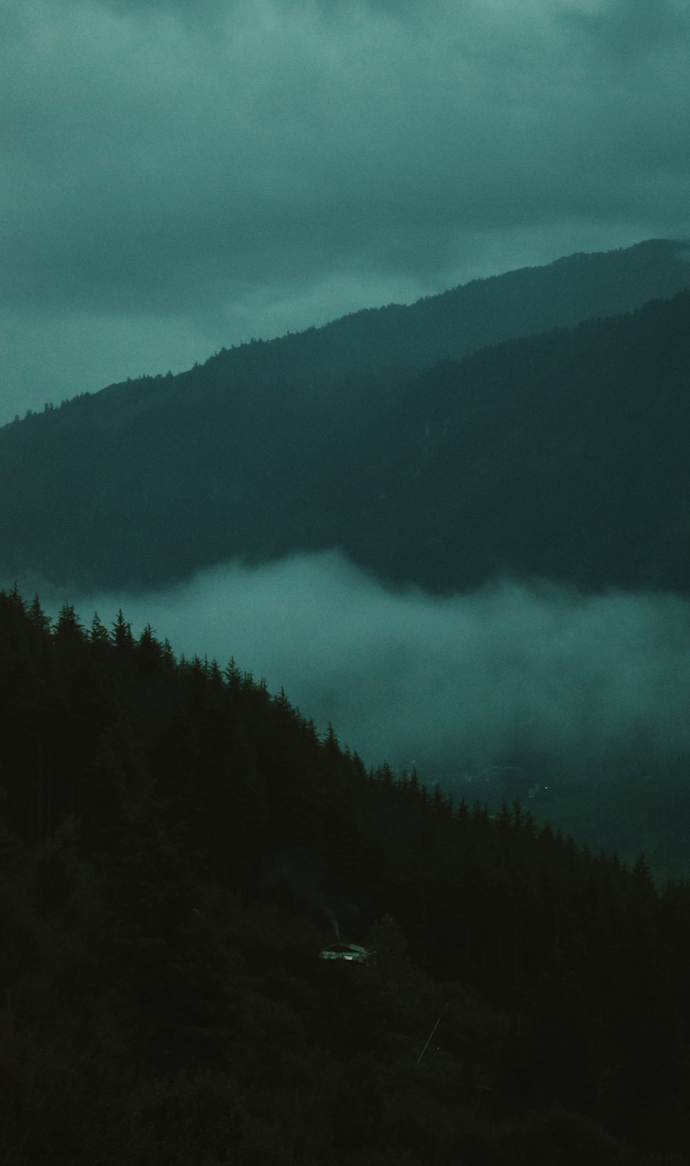 landscape photo of green mountains under white fogs