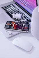 Bluetooth headset displayed alongside a smartphone and laptop on a modern workspace.