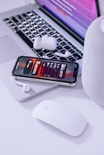 A sleek workspace featuring a laptop and wireless speaker on a modern desk.