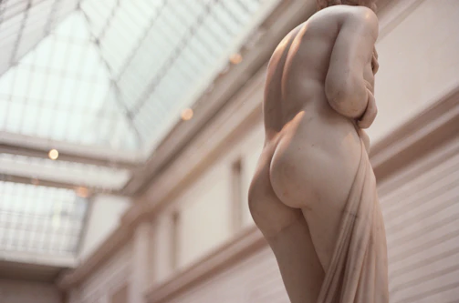 Finished marble sculptures displayed in a sunlit gallery space