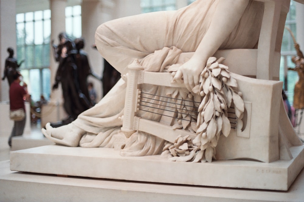 person sitting on chair statue