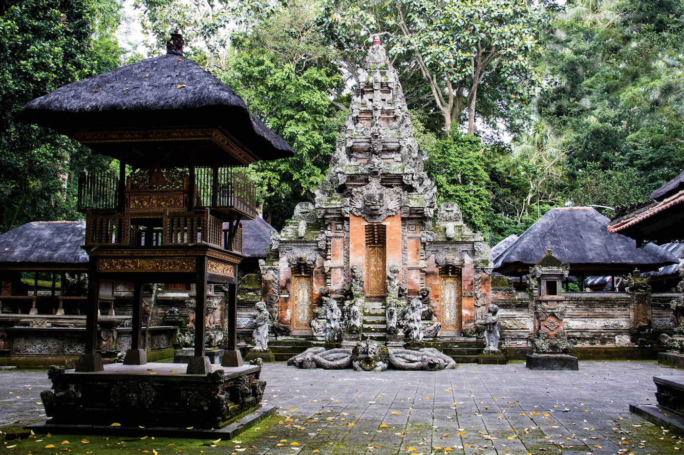 Moss-covered stone temple gate inside the Sacred Monkey Forest in Ubud