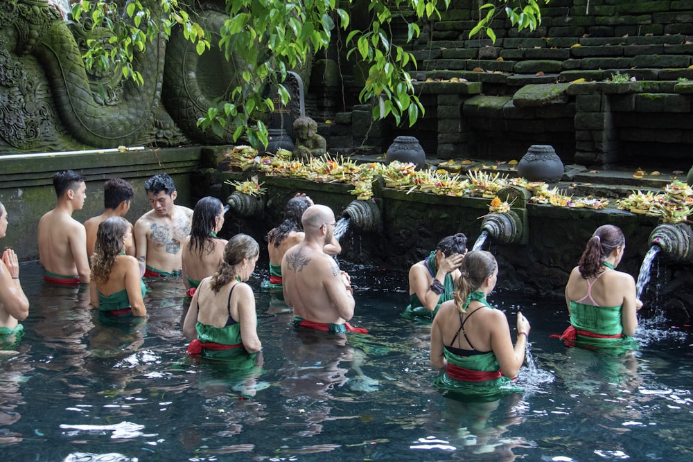 group of people standing on swimming pool