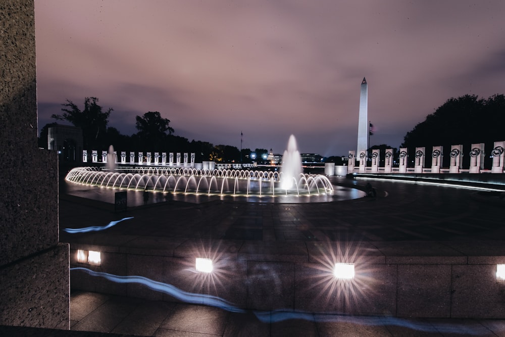 lighted obelisk and water fountain