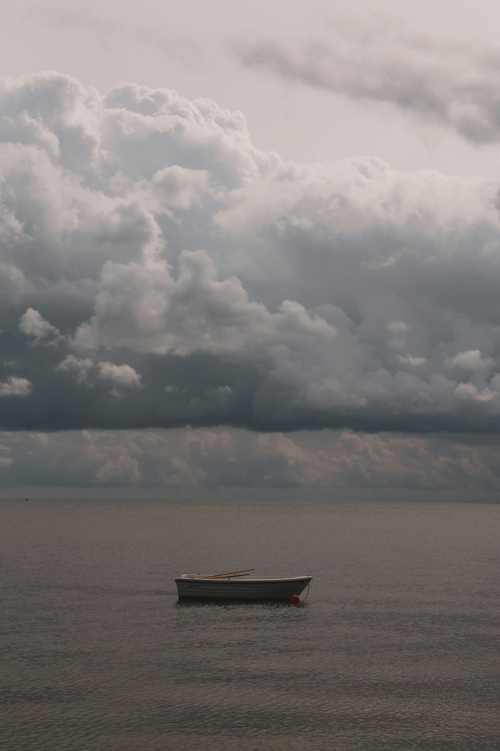 boat on sea under heavy clouds