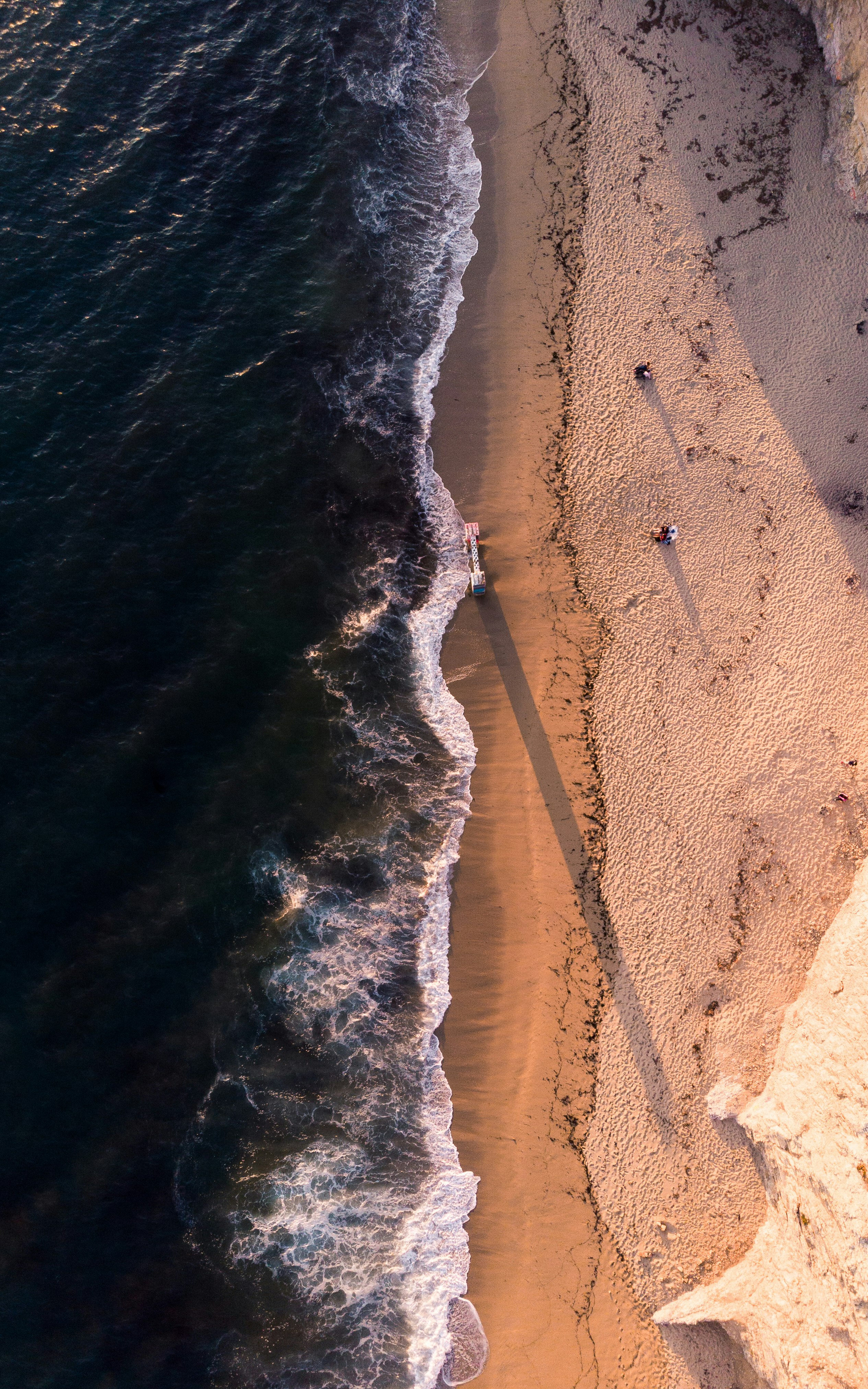 high-angle photo of shoreline and body of water