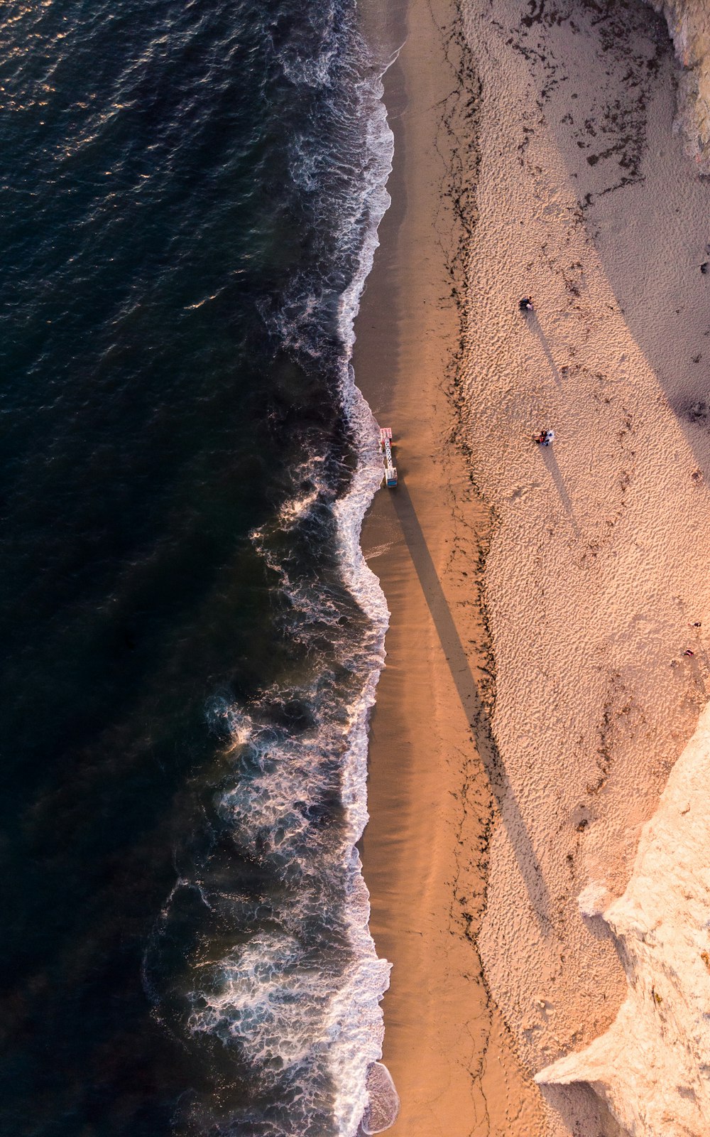 high-angle photo of shoreline and body of water