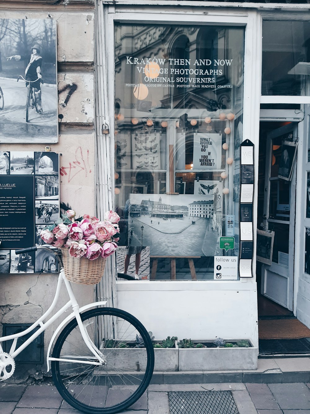 white bike parked outside clear glass establishment