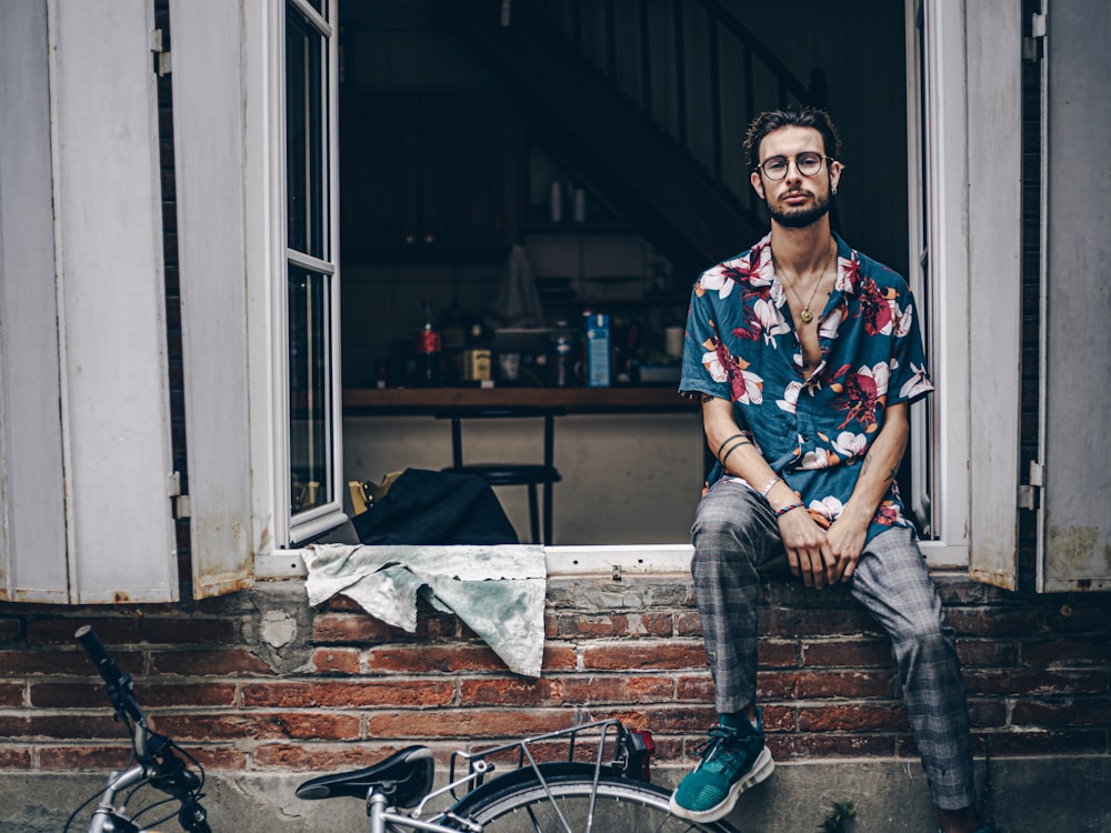 man sitting on window