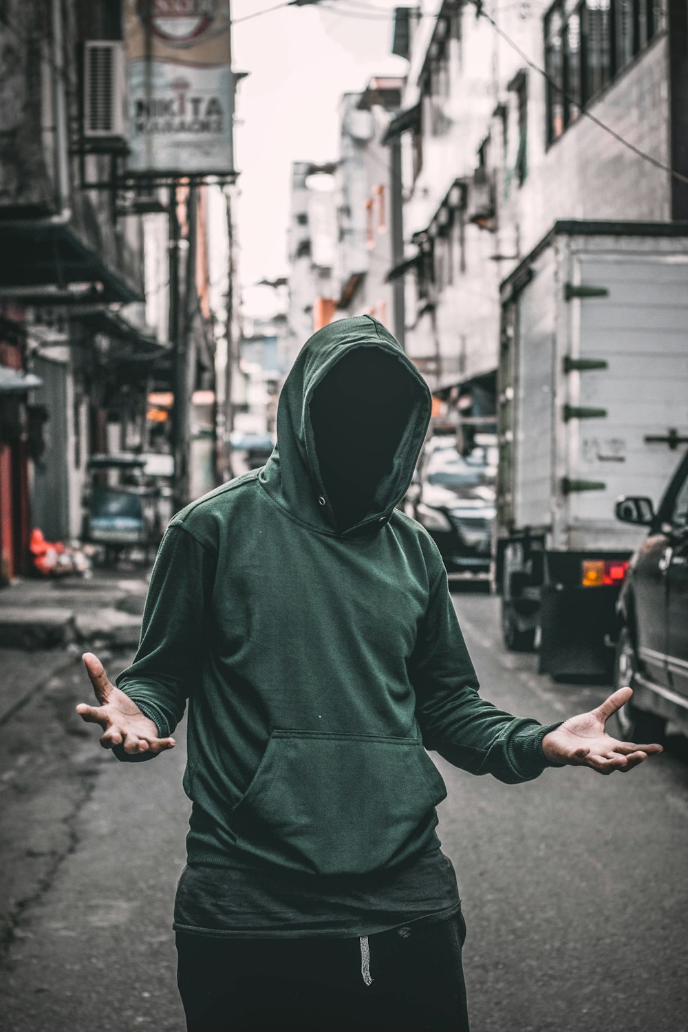 man wearing green hooded jacket