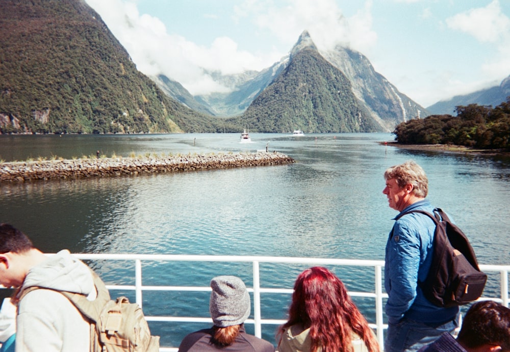 man and woman on boat near mountain