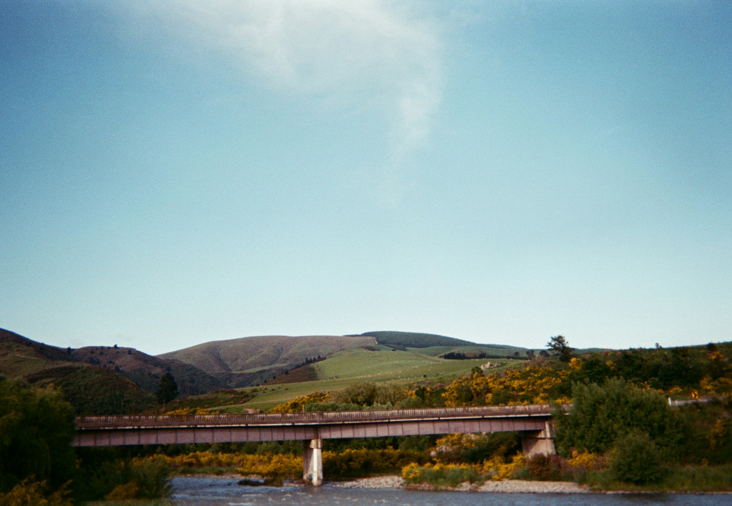 bridge and hill under blue sky