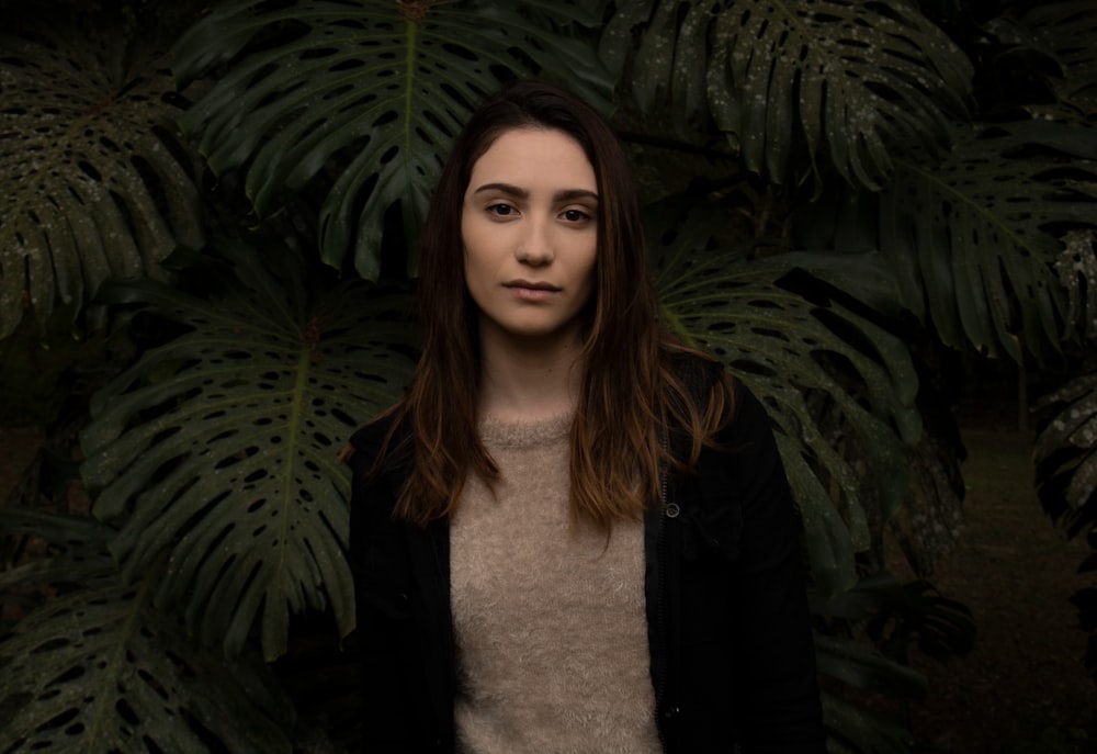 woman standing in front of green leafed plants