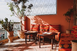 An inviting outdoor patio decorated with handmade cushions.