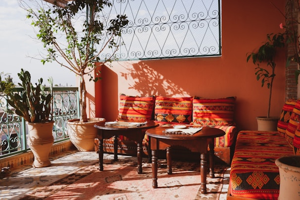 An inviting outdoor patio decorated with handmade cushions.
