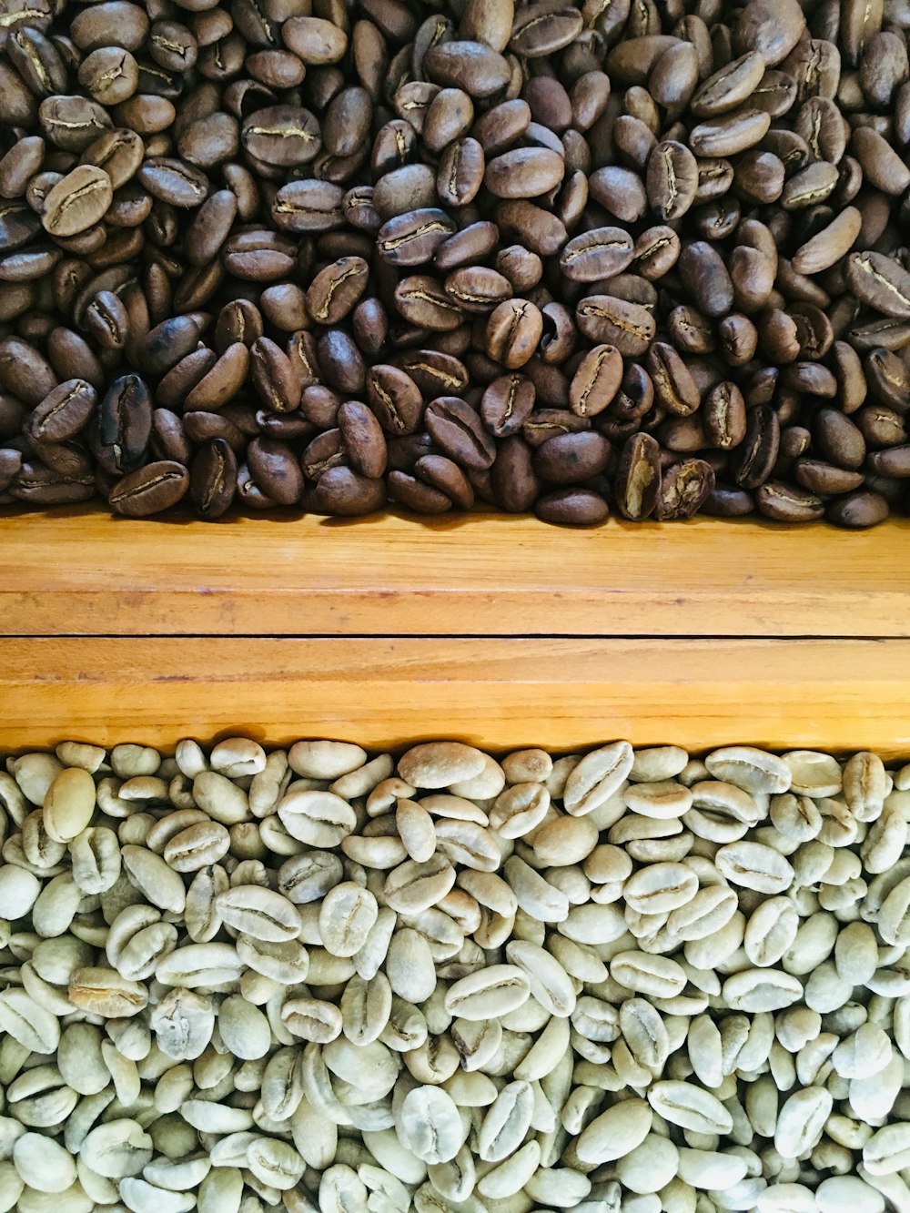 bunch of coffee beans on brown surface