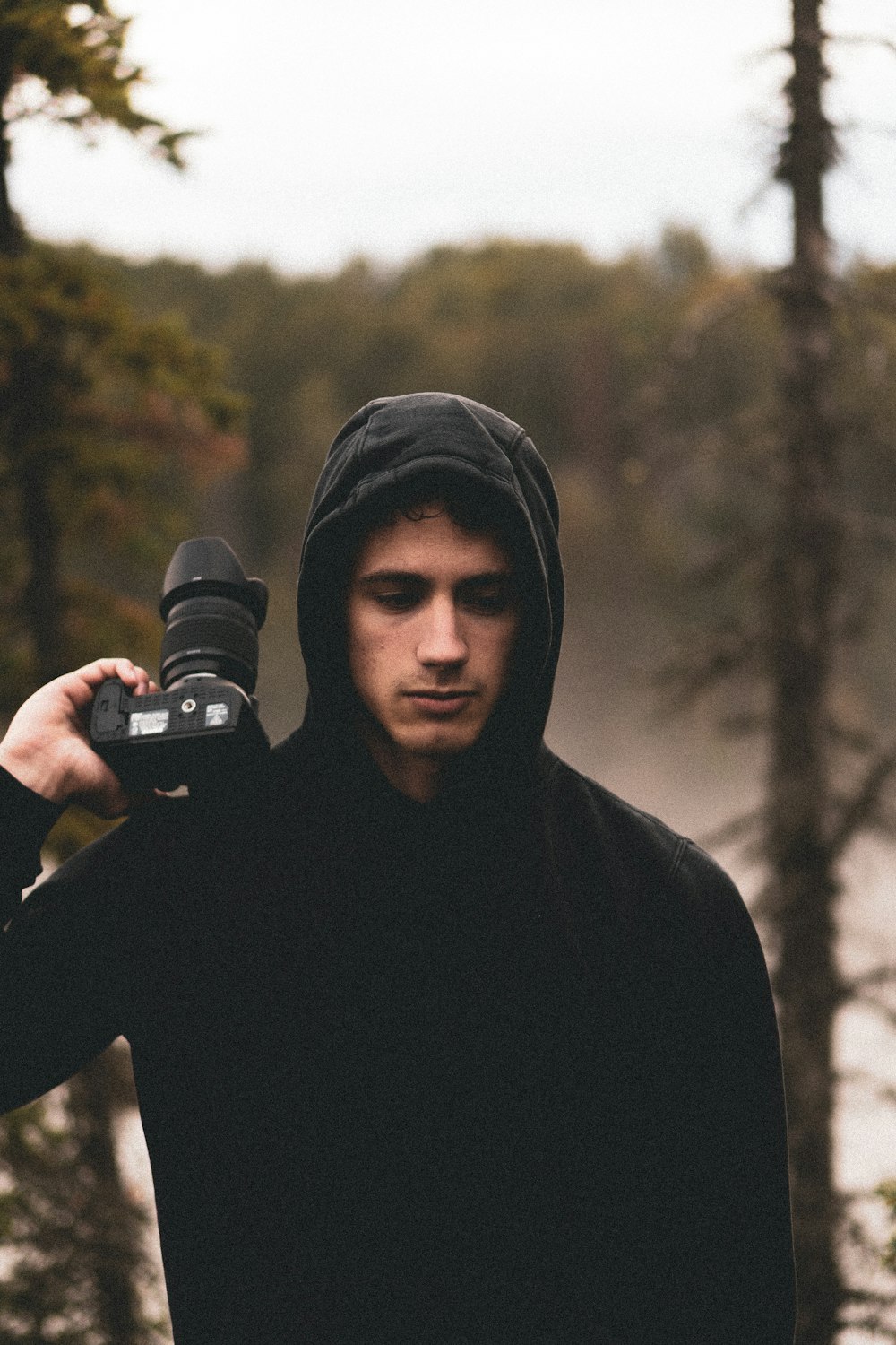 man holding black camera