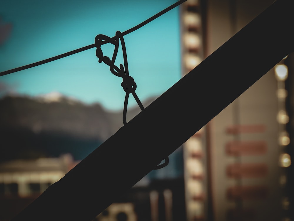 a close up of a rope with a building in the background