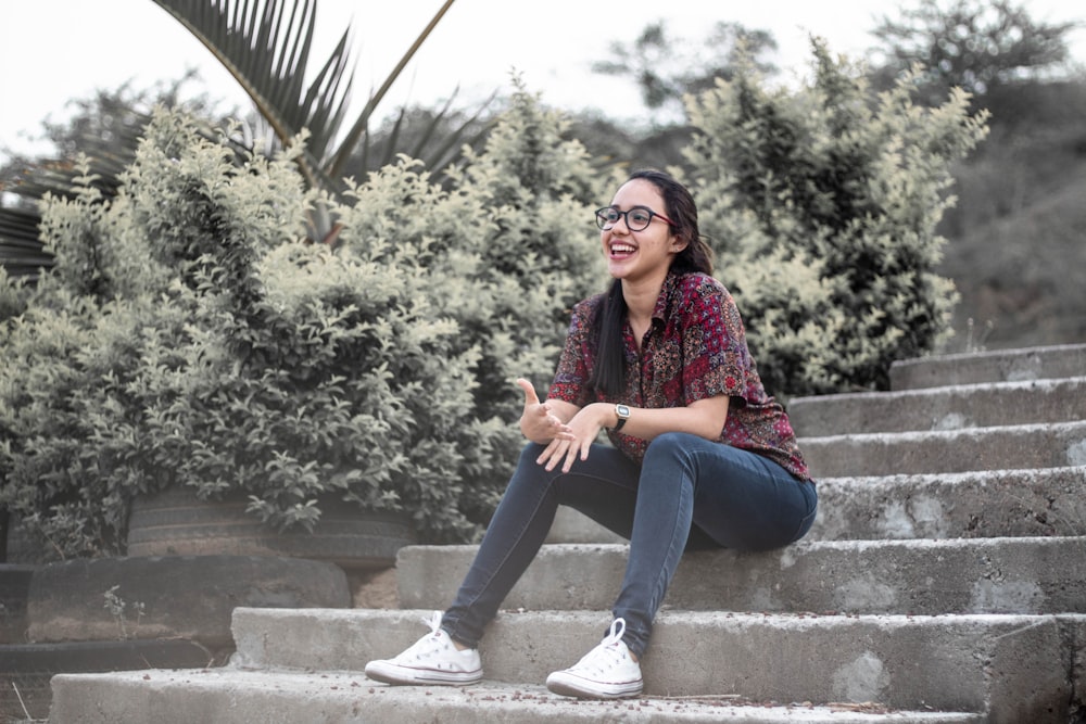 smiling woman sits on the stair