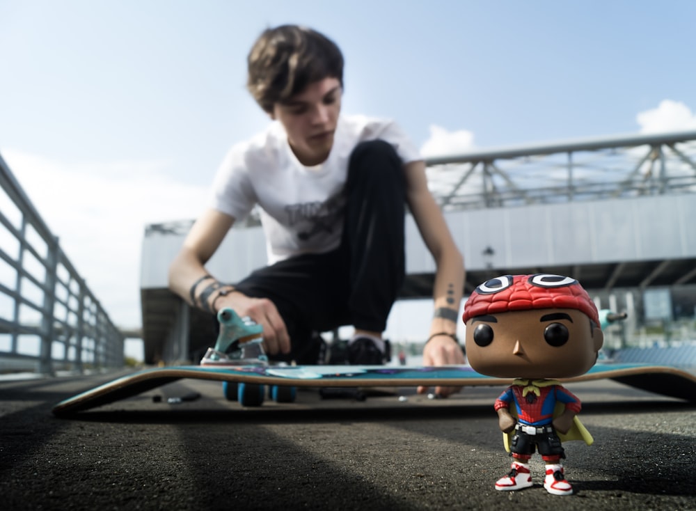 Pop! vinyl figure beside blue skateboard