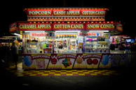 Children playing near the concession stand, holding colorful treats and smiling wide.